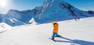 child skiing down slopes